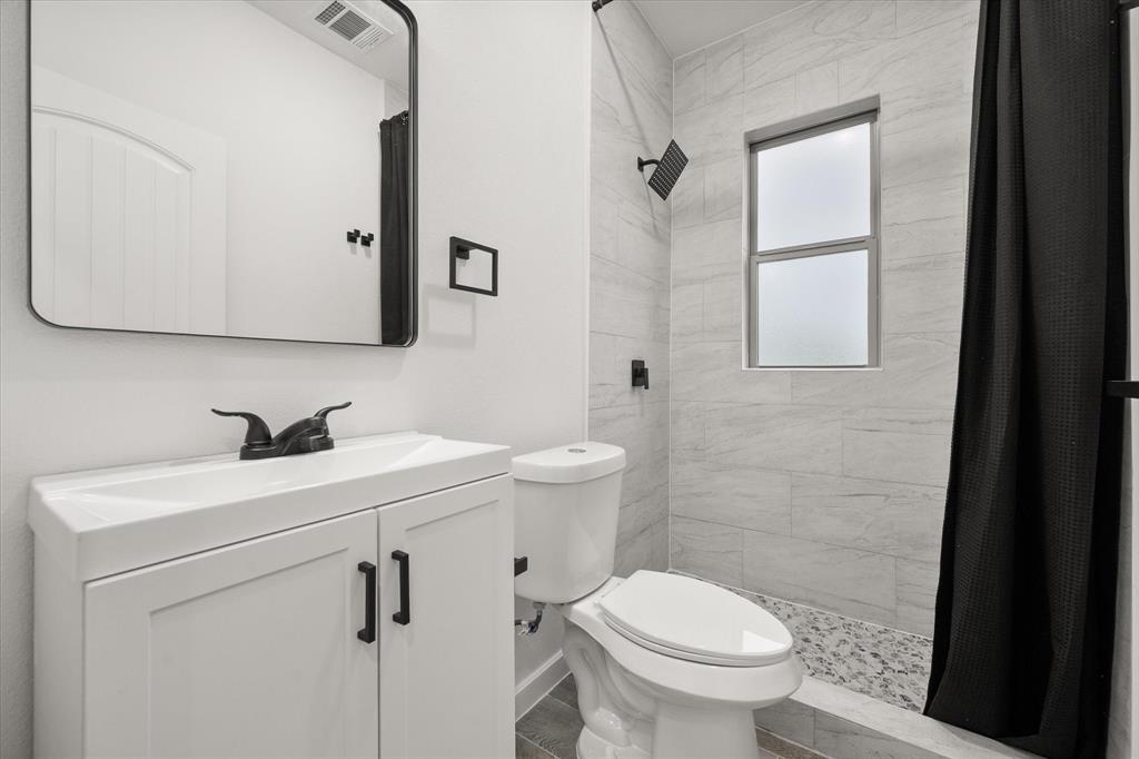 6771 Northwest County Road 1146 Barry, TX 75102 - Photo 21 of 34 a bathroom with a sink a toilet and a mirror