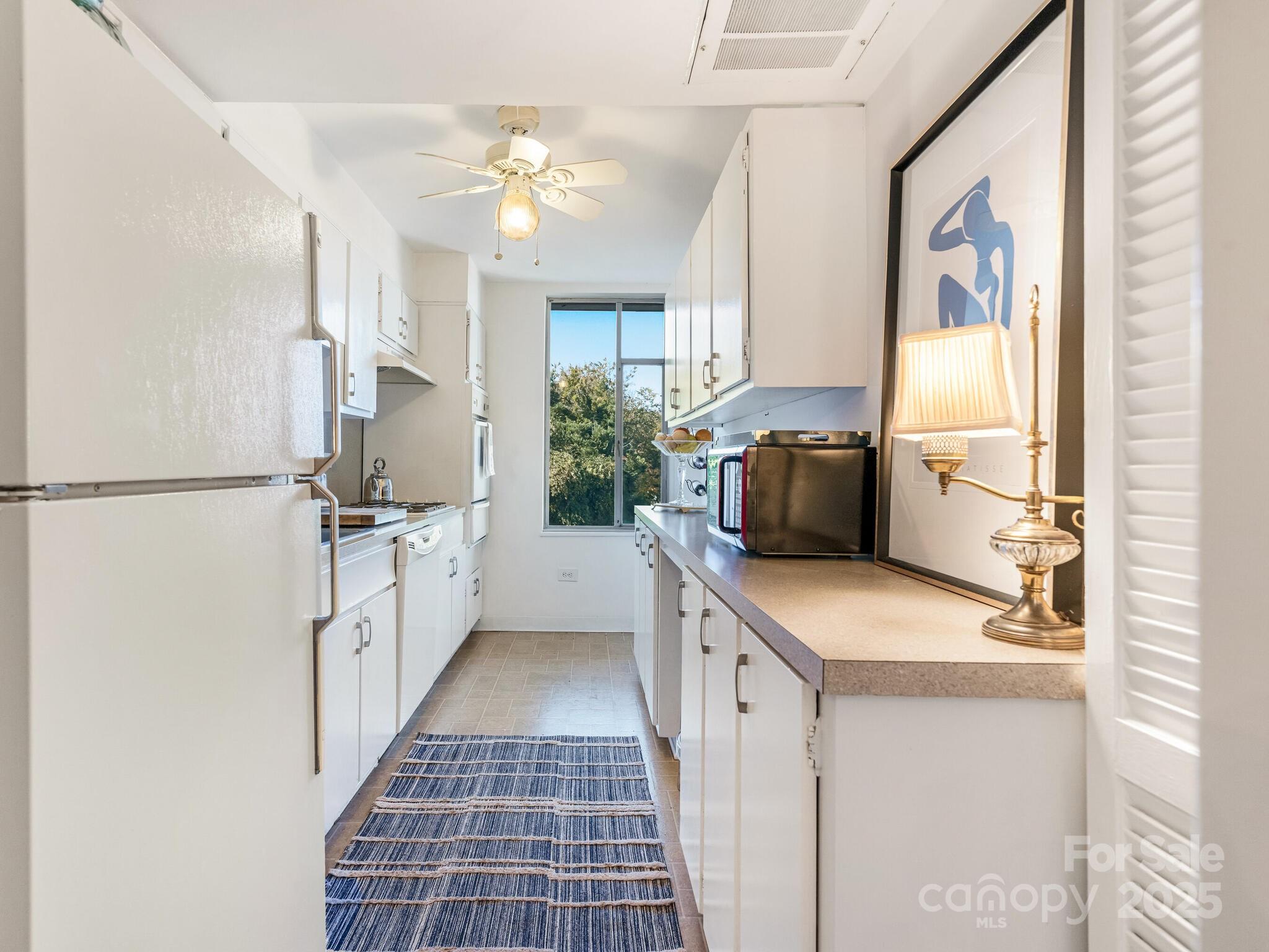 1300 Queens Road, Unit 401 Charlotte, NC 28207 - Photo 15 of 21 a kitchen with a sink appliances and cabinets