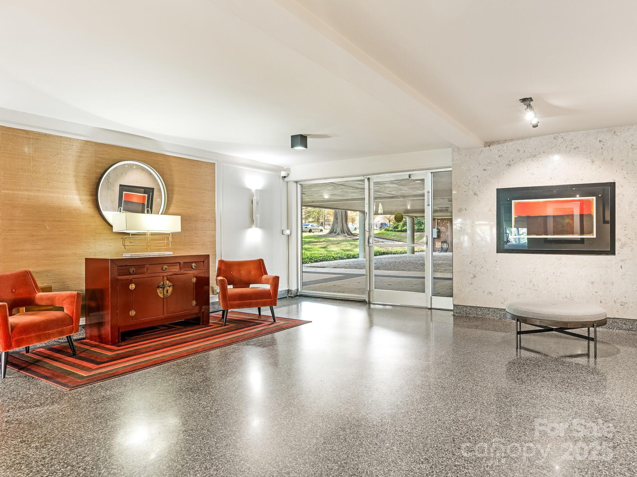 1300 Queens Road, Unit 401 Charlotte, NC 28207 - Photo 20 of 21 a living room with furniture and a flat screen tv