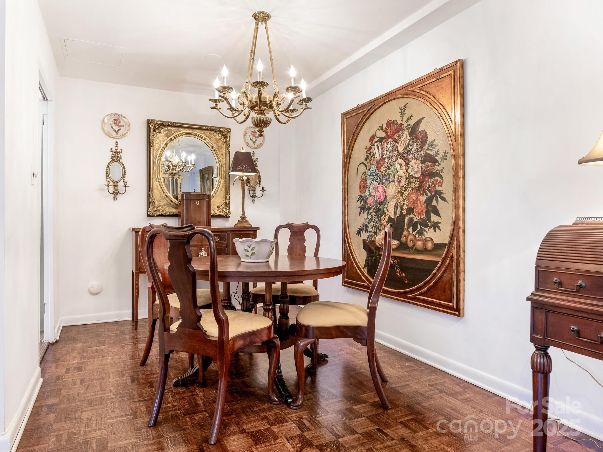 1300 Queens Road, Unit 401 Charlotte, NC 28207 - Photo 4 of 21 a view of a dining room with furniture and chandelier