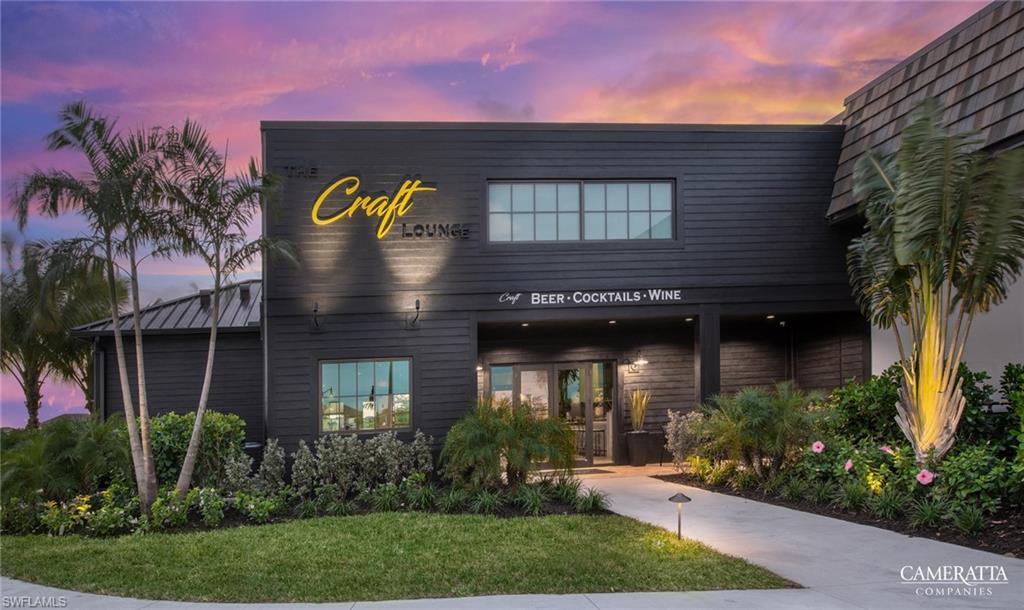 18364 Ridgeline Drive Estero, FL 33928 - Photo 42 of 50 Modern commercial building featuring dark horizontal siding and a prominent illuminated sign