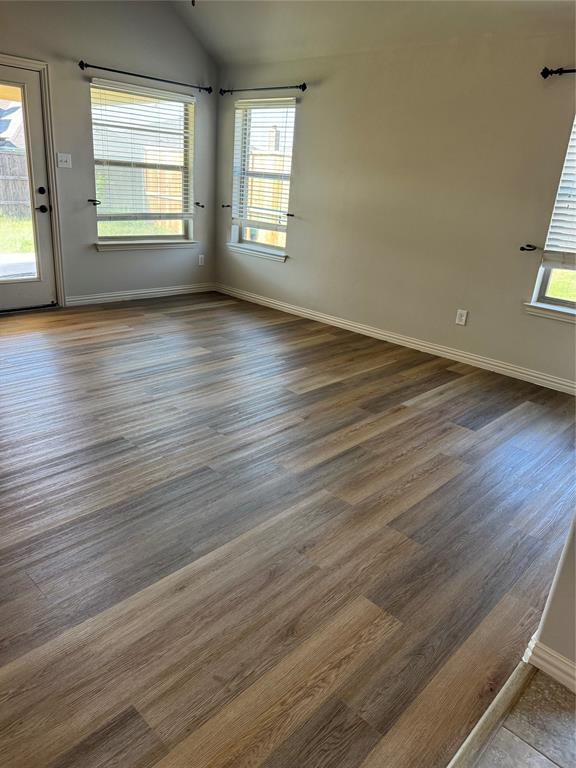 236 Archer Way Forney, TX 75126 - Photo 11 of 35 an empty room with wooden floor and windows