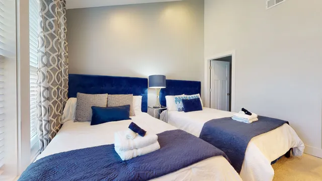 a bedroom with two beds and a wooden floor