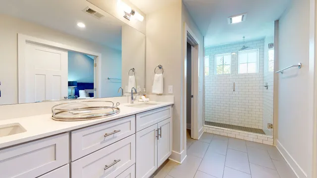 a bathroom with a granite countertop sink mirror and double