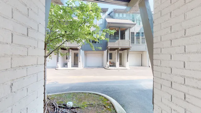 front view of a brick house with a clock on the wall