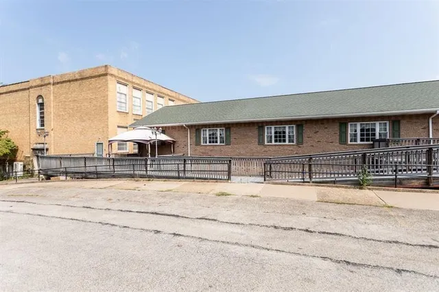 a view of a house with a snow on the road