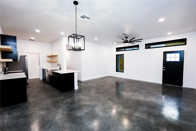a view of kitchen with sink microwave and refrigerator