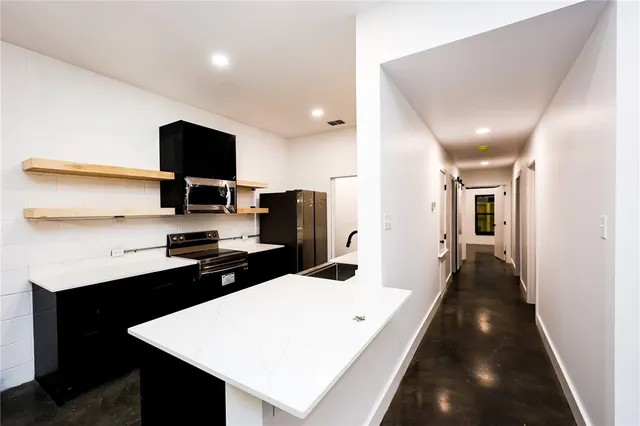 a kitchen with a sink stainless steel appliances and cabinets