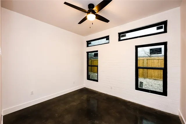 a view of a hallway with a window and a ceiling fan