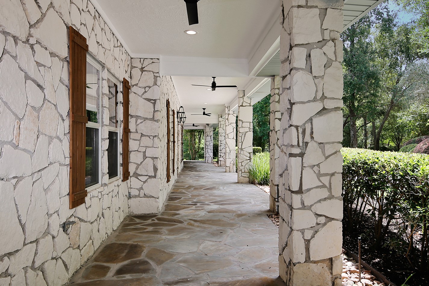26442 McDonald Road Spring, TX 77380 - Photo 40 of 50 Welcoming porch spans the front of the home and provides a great backdrop for rocking chairs or lounging.