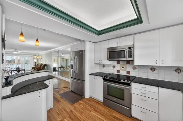 a kitchen with a sink stove and microwave