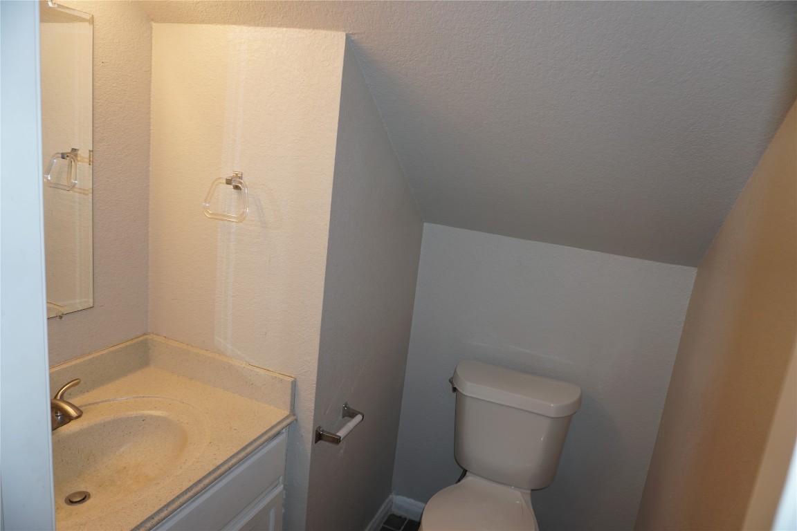 21218 Derby Day Avenue Pflugerville, TX 78660 - Photo 14 of 17 a bathroom with a granite countertop toilet and a sink