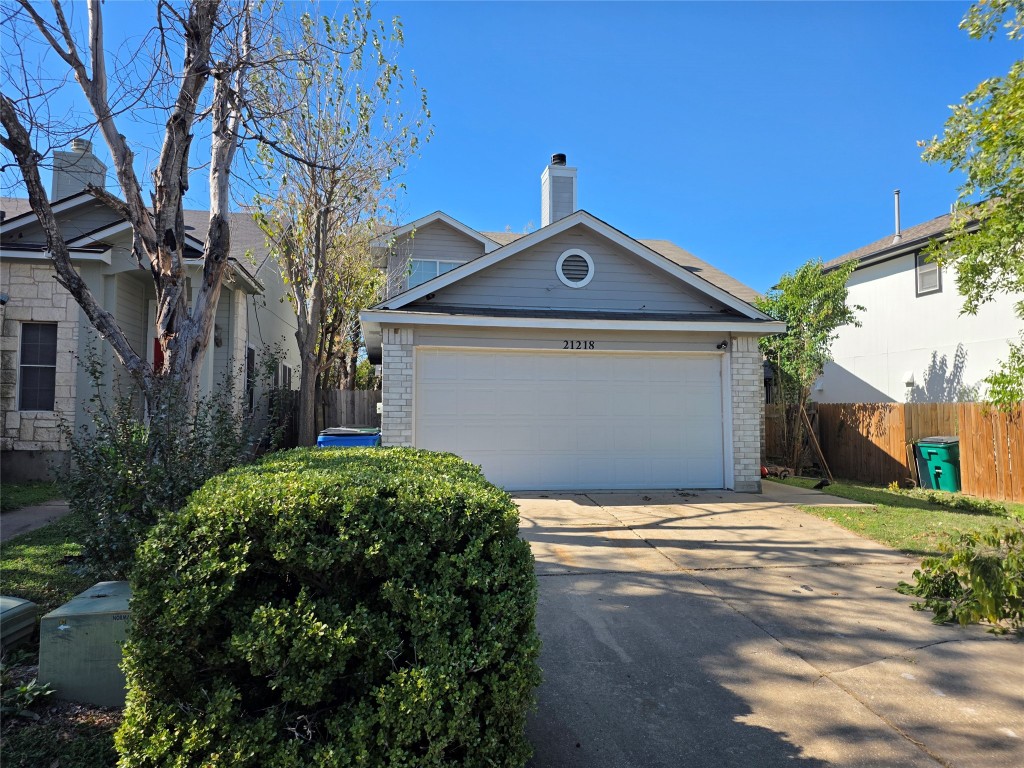 21218 Derby Day Avenue Pflugerville, TX 78660 - Photo 2 of 17 a front view of a house with garden