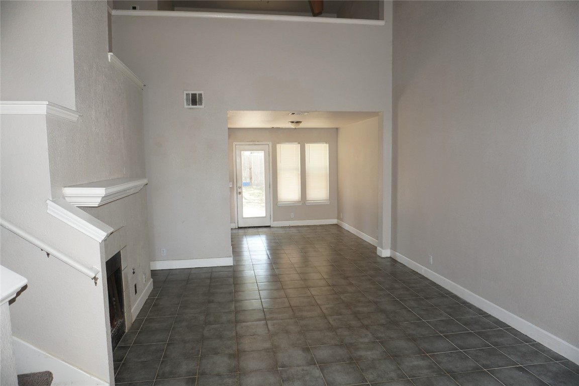 21218 Derby Day Avenue Pflugerville, TX 78660 - Photo 3 of 17 a view of a hallway with wooden floor and a window