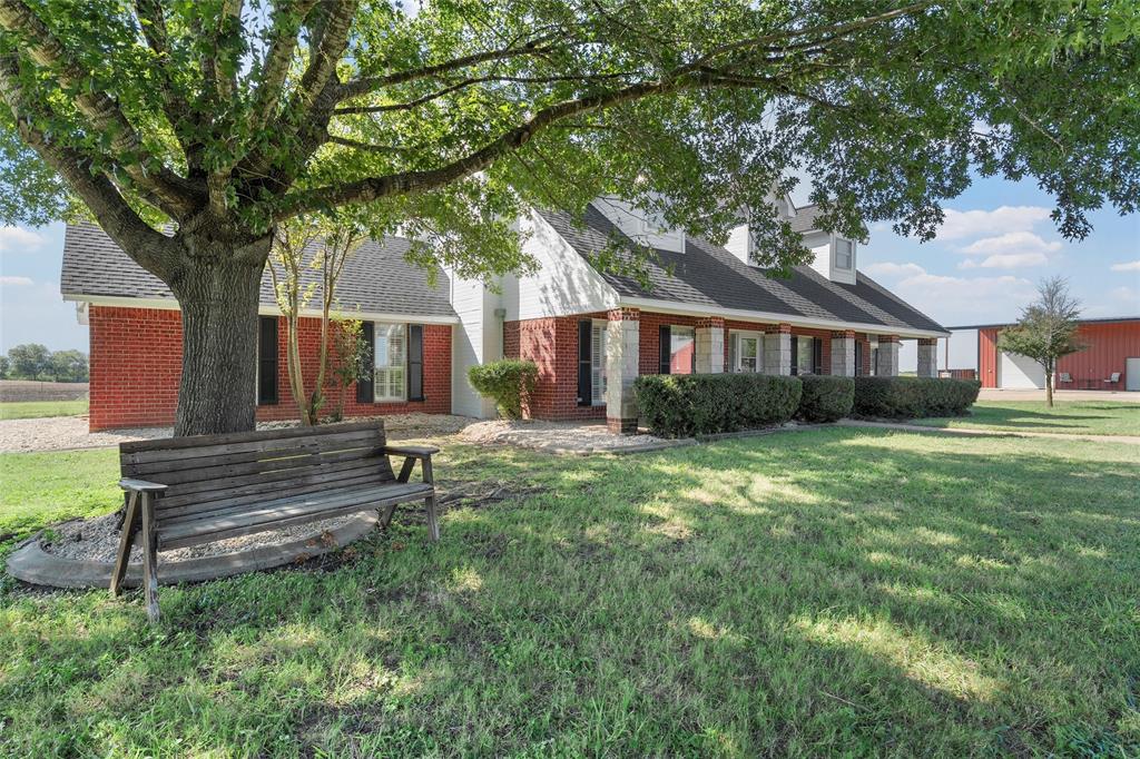 5112 Old Caufield Ranch Road McGregor, TX 76657 - Photo 3 of 38 View of front of house with brick siding, a front lawn, and a shingled roof