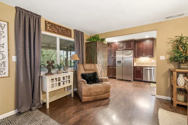 a kitchen with granite countertop a refrigerator and a sink