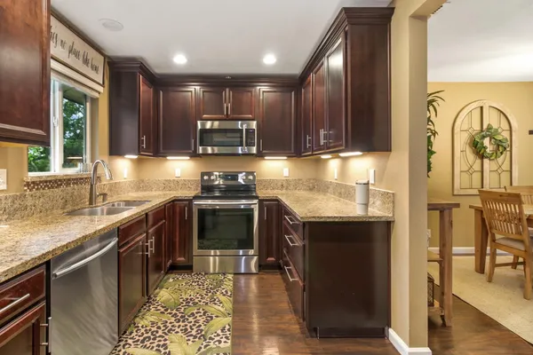 a kitchen with granite countertop a sink and a granite counter top