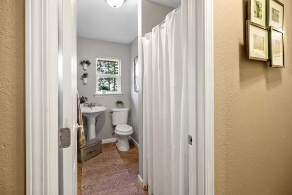 a bathroom with a toilet a sink and a mirror