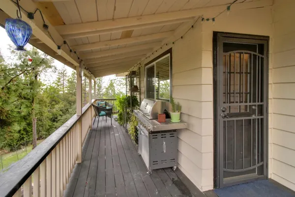 a view of a roof deck with two chair and wooden fence