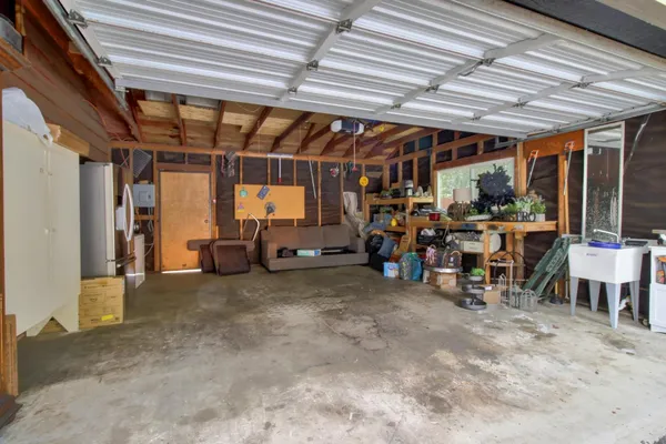 a backyard of a house with table and chairs