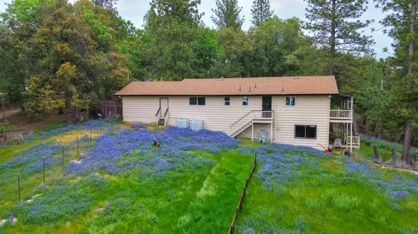 a view of a house with a deck and furniture