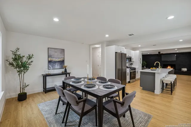a view of a dining room with furniture and a potted plant