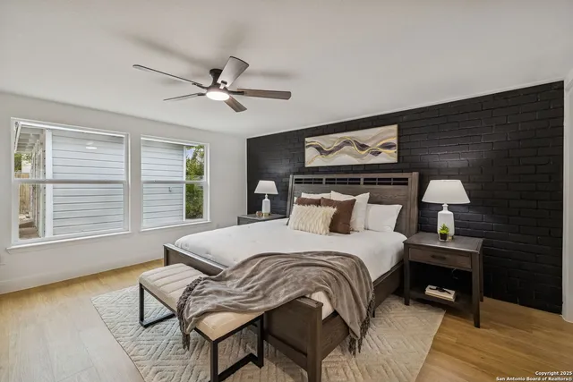 a bedroom with a bed and wooden floor