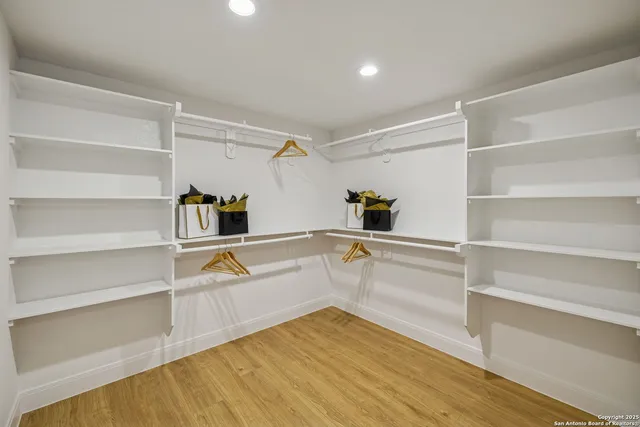 a view of walk in closet with empty racks