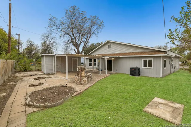 a backyard of a house with table and chairs