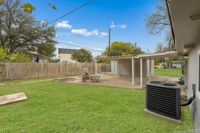 a view of a house with backyard sitting area and garden