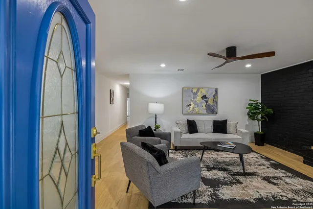 a living room with furniture and a flat screen tv