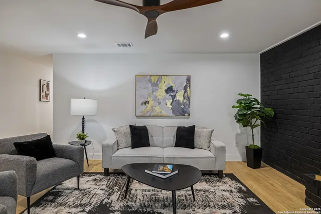 a living room with furniture potted plant and a lamp