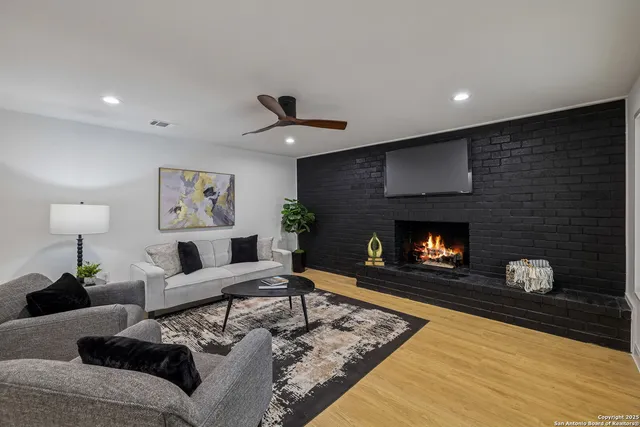 a living room with furniture and a fireplace