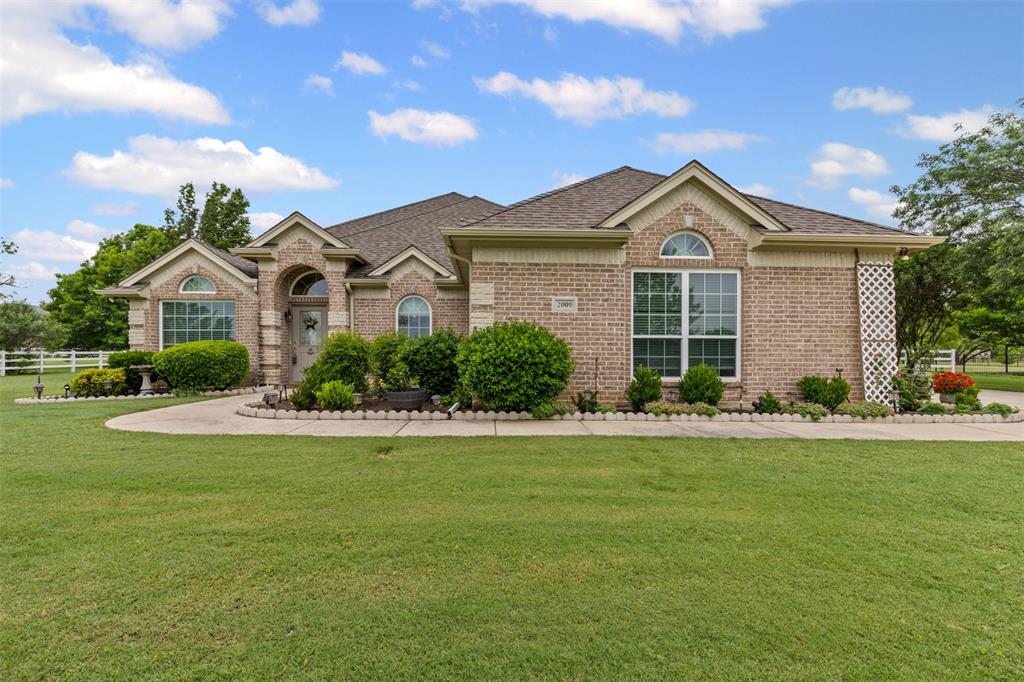 2009 Running Brook Drive Joshua, TX 76058 - Photo 1 of 35 a front view of a house with a garden