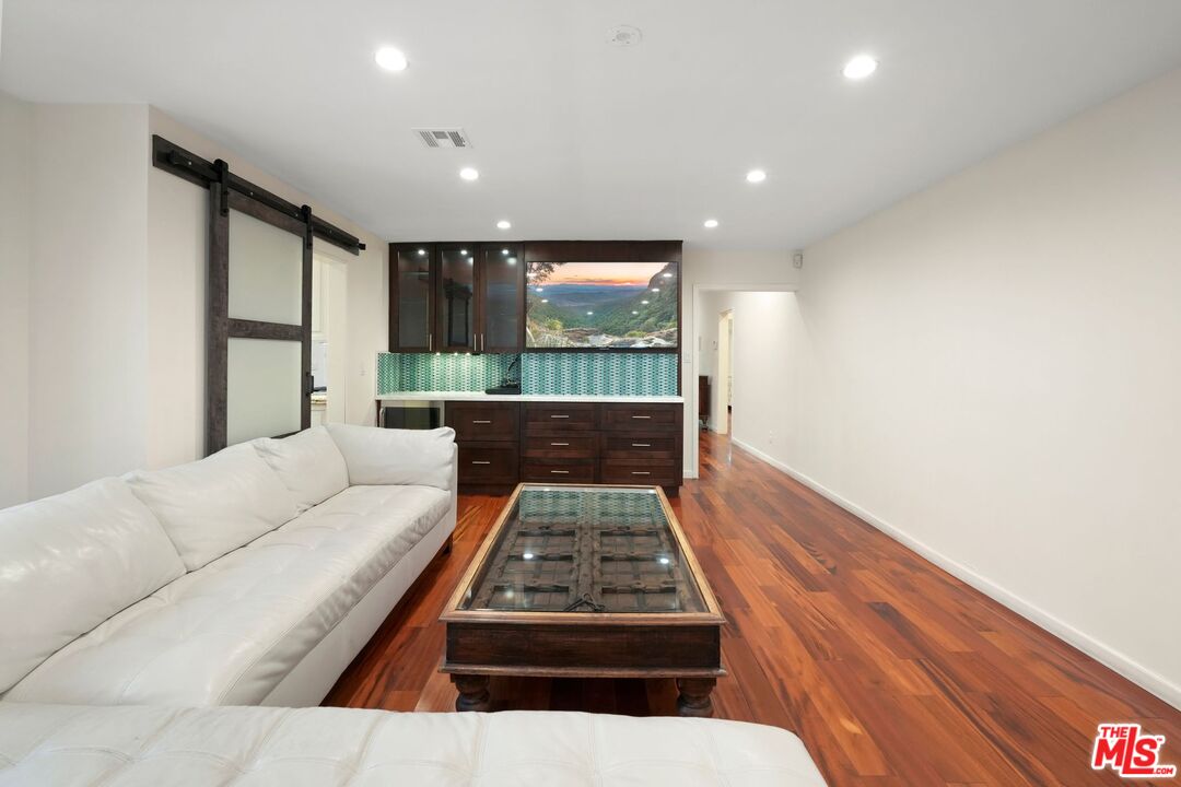 5324 Irvine Avenue Valley Village, CA 91601 - Photo 13 of 33 a living room with a couch and a flat screen tv