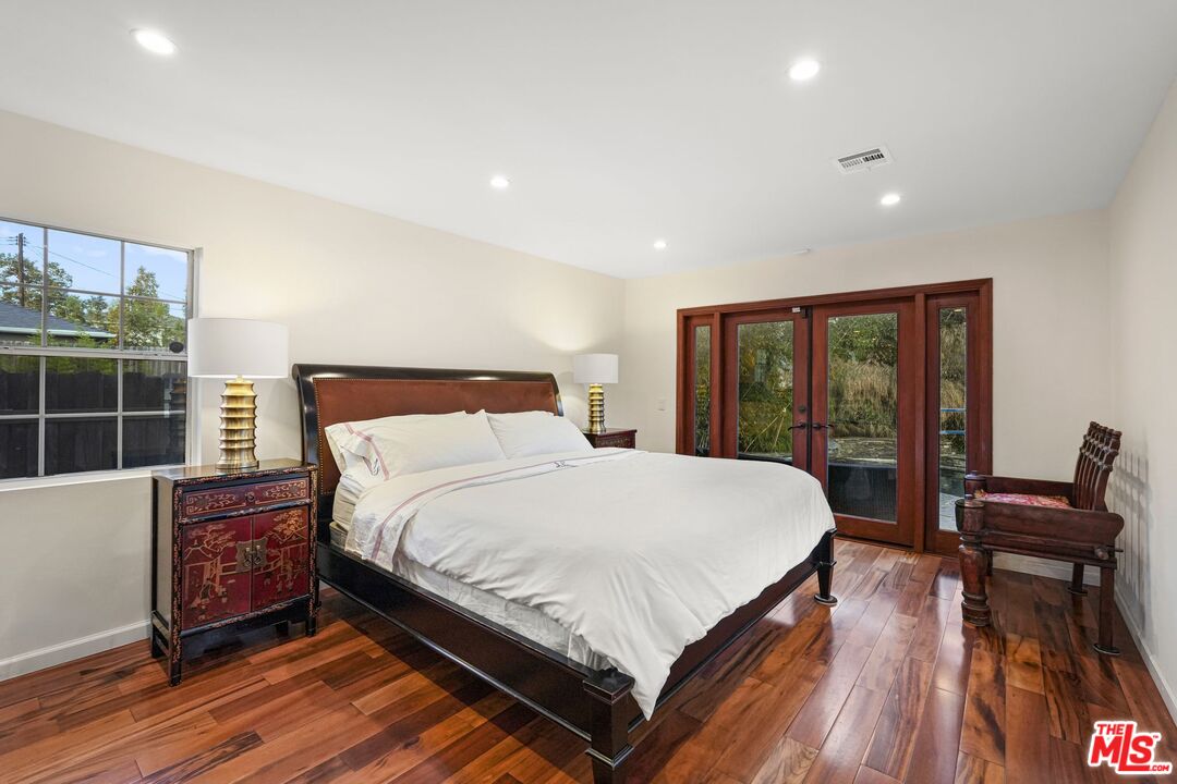 5324 Irvine Avenue Valley Village, CA 91601 - Photo 15 of 33 a large bedroom with a bed and wooden floor