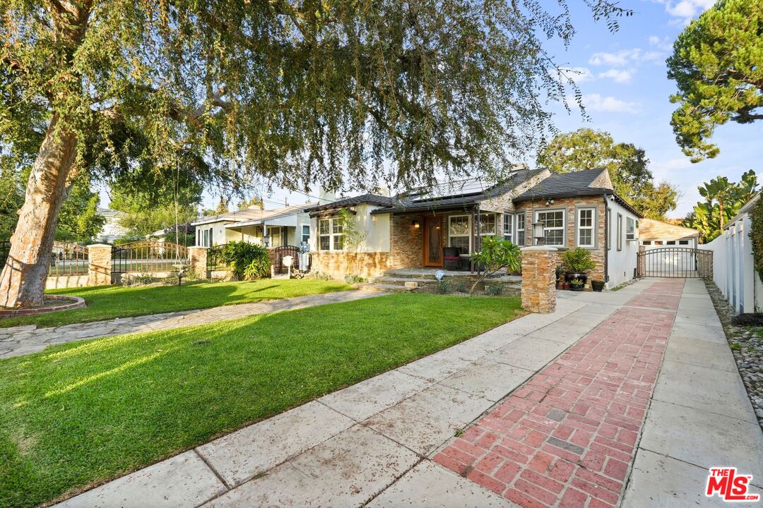 5324 Irvine Avenue Valley Village, CA 91601 - Photo 2 of 33 a front view of a house with a garden