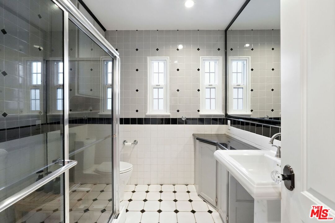 5324 Irvine Avenue Valley Village, CA 91601 - Photo 21 of 33 a bathroom with a sink a toilet and shower