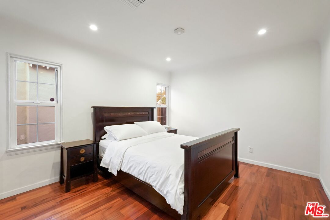 5324 Irvine Avenue Valley Village, CA 91601 - Photo 23 of 33 a bedroom with a bed and wooden floor