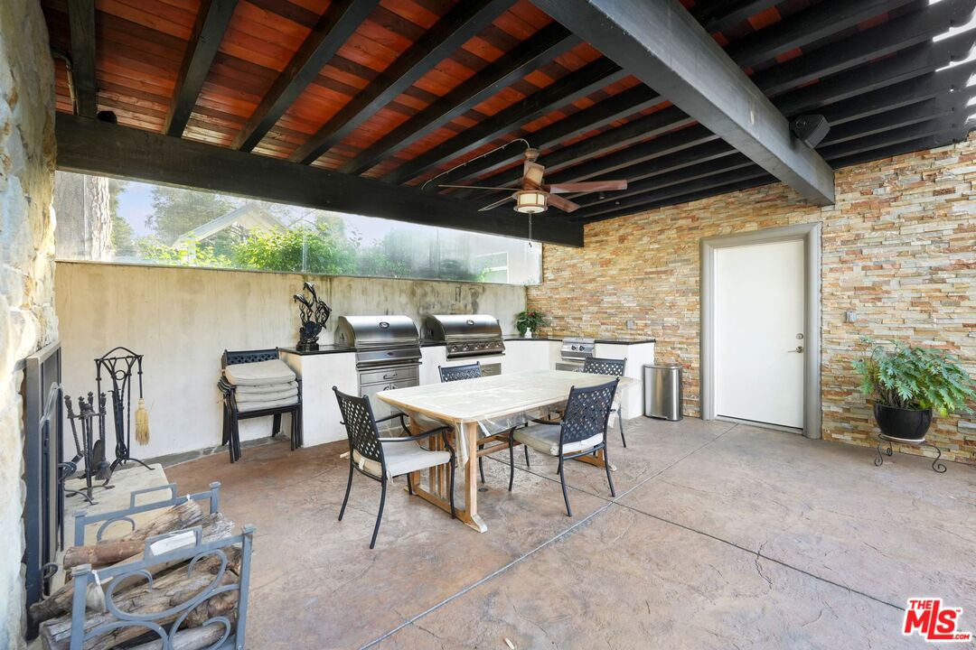 5324 Irvine Avenue Valley Village, CA 91601 - Photo 26 of 33 a view of a patio with table and chairs with wooden floor and fence