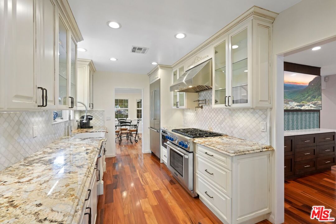5324 Irvine Avenue Valley Village, CA 91601 - Photo 9 of 33 a kitchen with stainless steel appliances granite countertop a stove and a sink