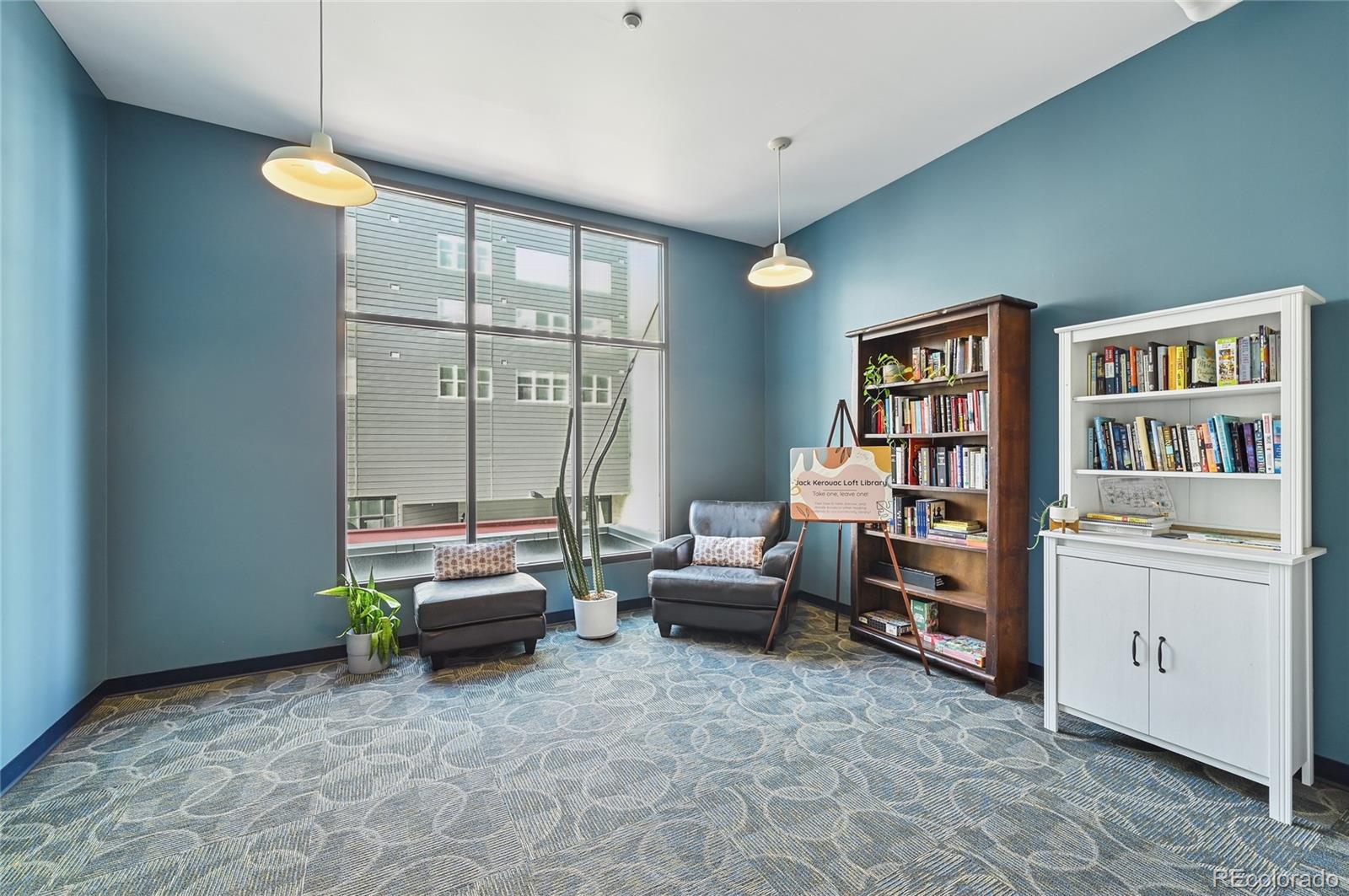 3100 Huron Street, Unit 2C Denver, CO 80202 - Photo 18 of 18 a living room with furniture and a book shelf