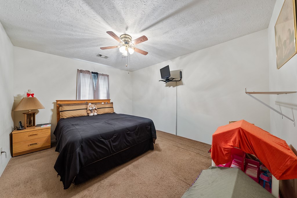 6223 Georgetown Drive Columbus, GA 31907 - Photo 17 of 29 a bedroom with a bed and a chandelier