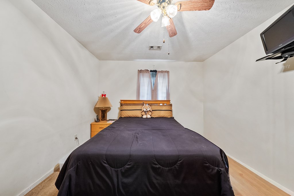 6223 Georgetown Drive Columbus, GA 31907 - Photo 18 of 29 a bedroom with a bed and a flat screen tv