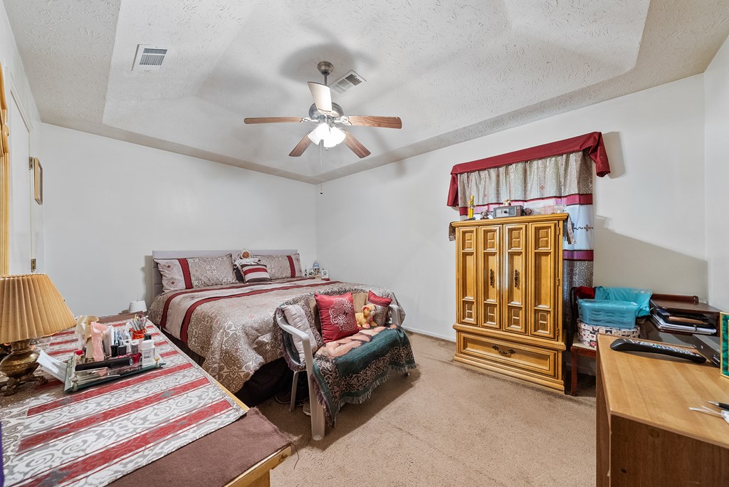 6223 Georgetown Drive Columbus, GA 31907 - Photo 19 of 29 a bedroom with a bed and a chandelier