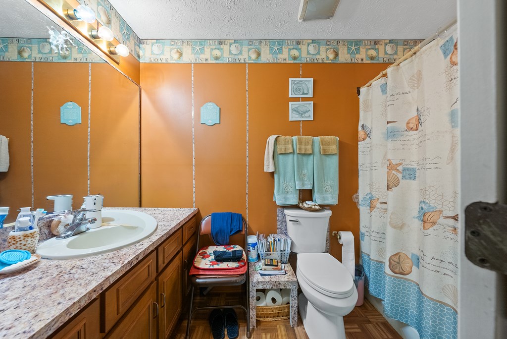 6223 Georgetown Drive Columbus, GA 31907 - Photo 21 of 29 a bathroom with a granite countertop toilet sink and shower