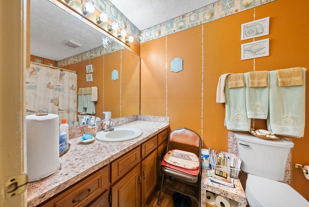 6223 Georgetown Drive Columbus, GA 31907 - Photo 22 of 29 a bathroom with a granite countertop sink and a mirror