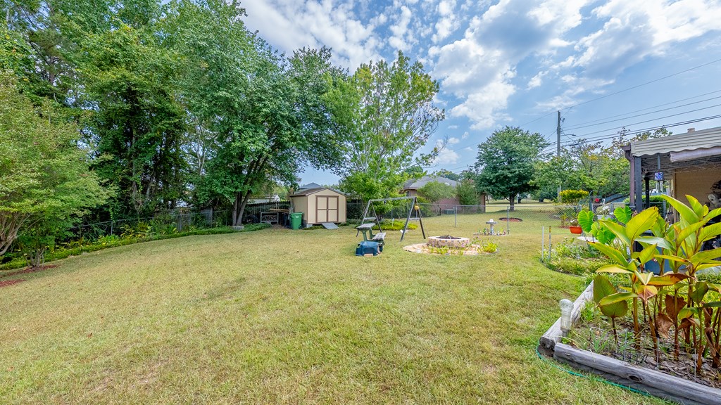 6223 Georgetown Drive Columbus, GA 31907 - Photo 29 of 29 a view of a swimming pool with a patio and a yard