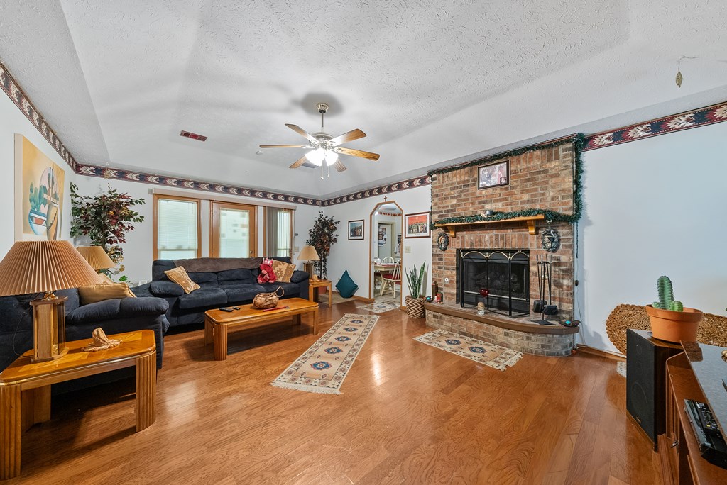 6223 Georgetown Drive Columbus, GA 31907 - Photo 5 of 29 a living room with furniture a fireplace and a flat screen tv