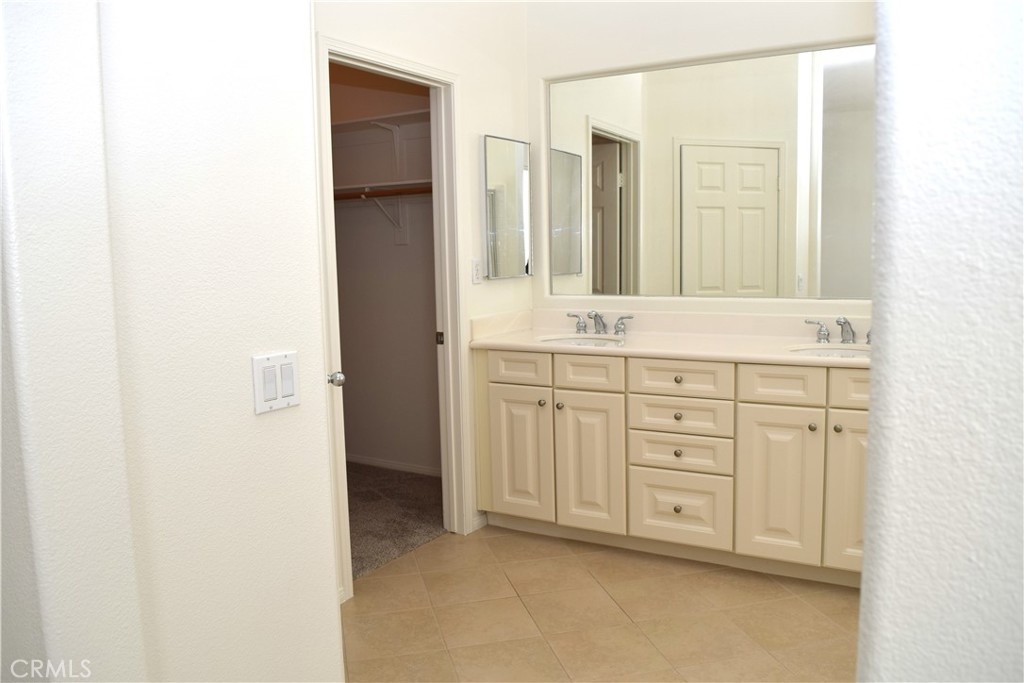 39723 Clements Way Murrieta, CA 92563 - Photo 14 of 20 a bathroom with a sink and a mirror